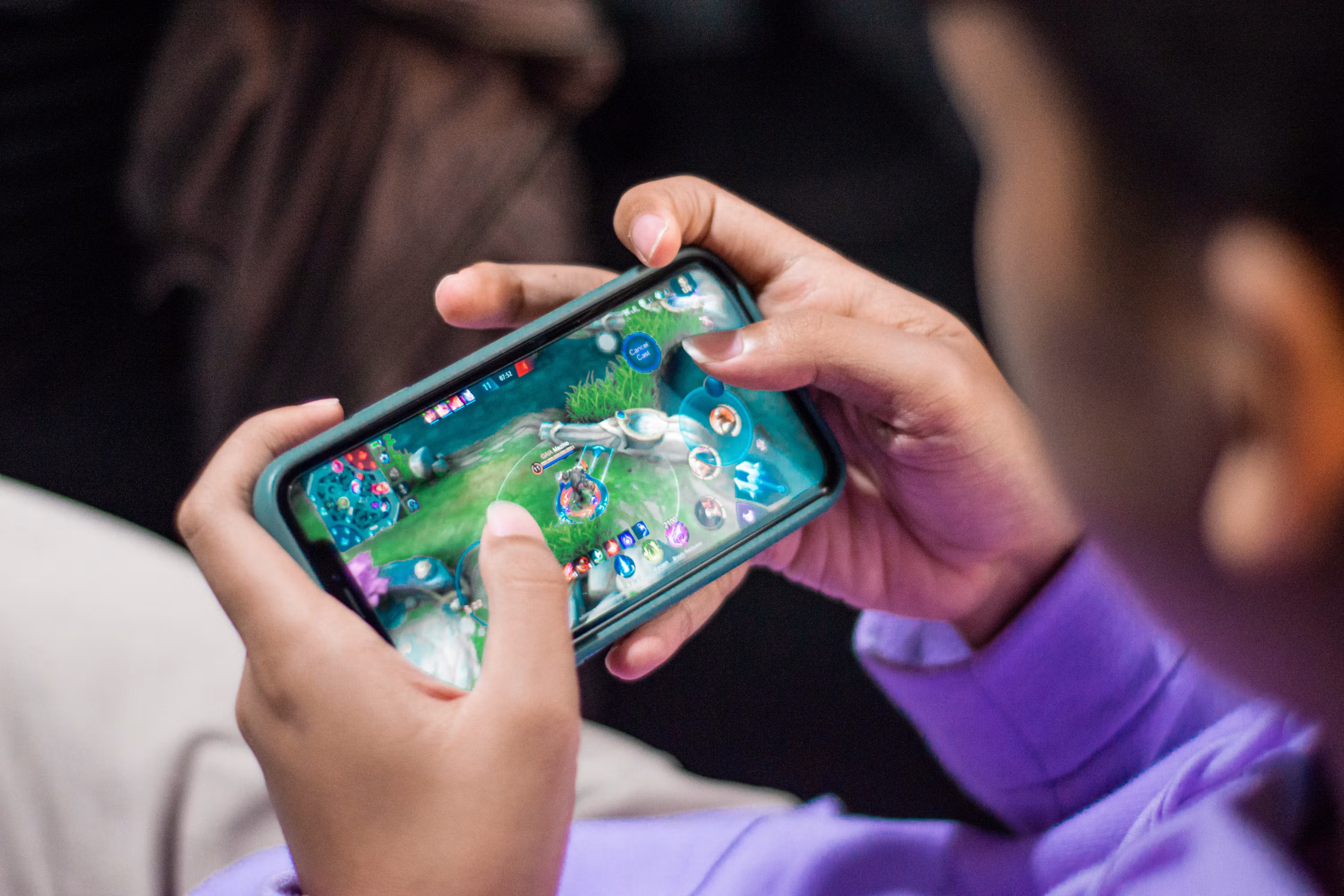 Smartphone displaying a fictional mobile game at an Australian gaming technology exhibition